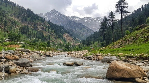 Fototapeta Scenic river flowing through lush green valley surrounded by majestic mountains and trees