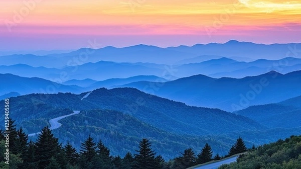 Obraz Serene sunset over misty mountain ranges with winding roads and vibrant sky colors