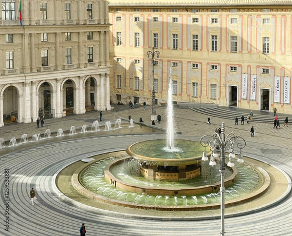 Obraz Genoa, Italy - January 24, 2025. Piazza Ferrari with fountain in Genoa. Buildings and architecture of old town. View from above on sunny winter day in 2025. 