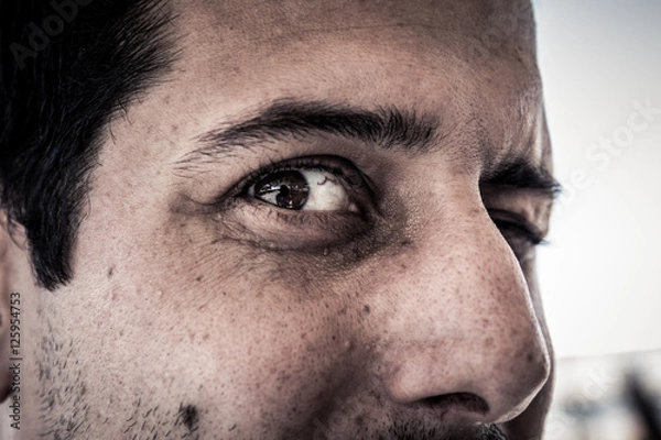 Obraz Closeup on face of scary creepy spooky man with evil eyes looking at camera