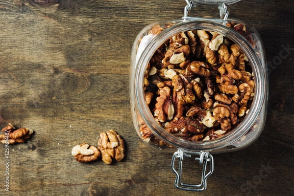 Obraz Shelled walnuts in jar.