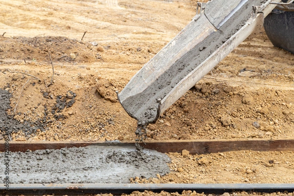 Obraz Worker pouring wet concrete