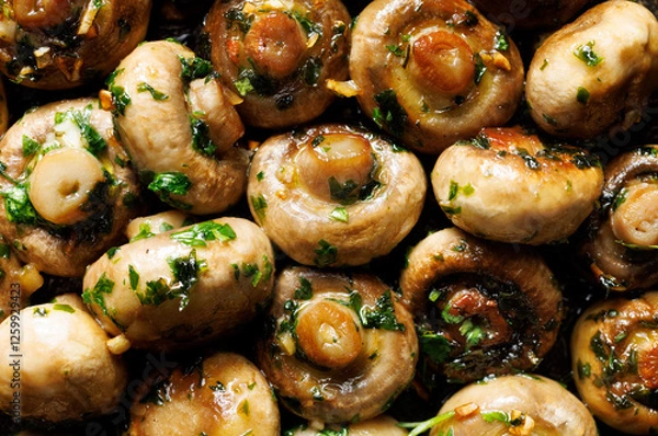 Obraz Garlic butter mushrooms with parsley and black pepper, close-up view. Mushroom background