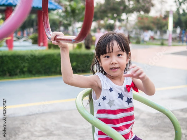 Fototapeta Happy asian baby child playing on playground