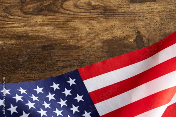Obraz Top view of american flag on bottom of a dark wooden table top with copy space, suitable for national us events like Presidents day, Labor day, Memorial Day, Independence day, Veterans day