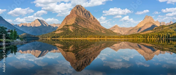 Fototapeta Sunrise golden light panorama from the Many Glacier Hotel - reflection on Swiftcurrent Lake of Grinnell Point - Glacier national Park