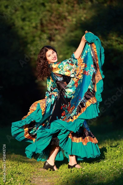 Fototapeta Beautiful gypsy girl in a traditional dance in the woods