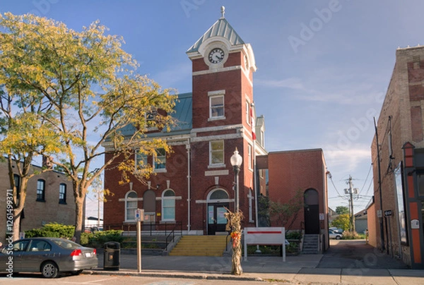 Fototapeta The building of Port Perry Post Office on Queen Street in the town of Port Perry in Ontario, Canada. The structure is a two-storey red brick building with a white dressed-stone foundation and a clock