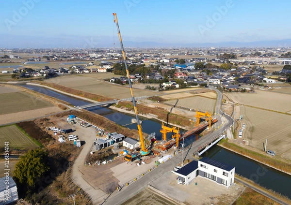 Fototapeta 道路拡張のための橋の架け替え工事　新しい橋の建設工事風景空撮