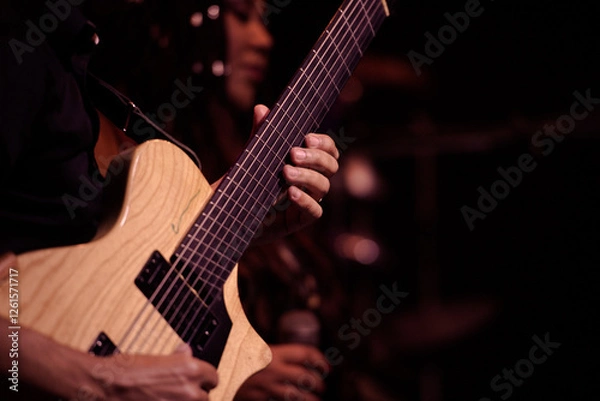 Obraz Close-up of a musician playing an electric guitar during a jazz performance.