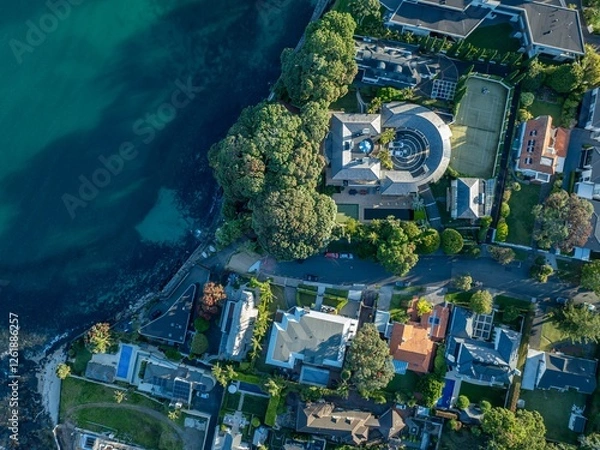 Fototapeta High-angle view of luxurious waterfront homes. Coastal properties with manicured gardens, pools, and tennis courts. A beautiful residential neighborhood. TAKAPUNA, AUCKLAND, NZ