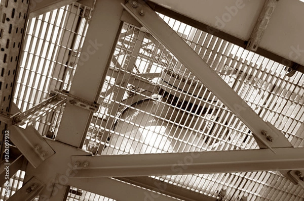 Fototapeta Close-up view of a durable industrial metal grid structure showcasing functional engineering design