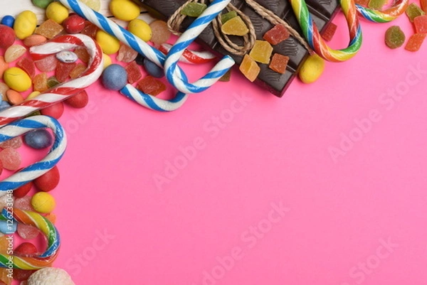 Fototapeta Pink background with colorful dragee