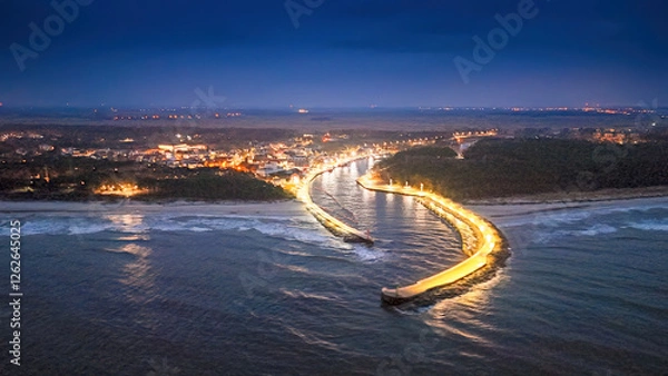 Obraz View from a drone at night of the river estuary into the sea in a seaside town