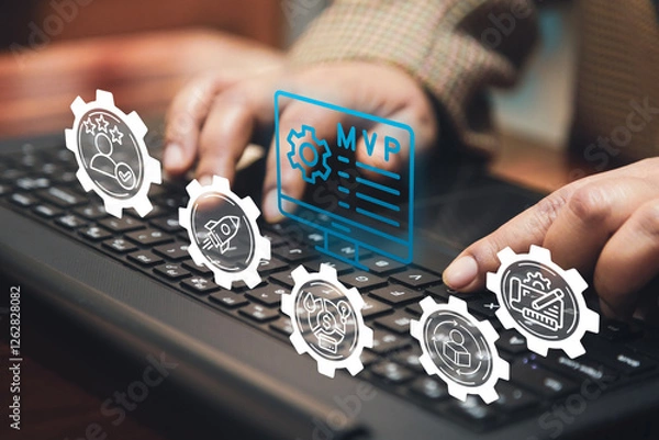 Fototapeta A business person types on a keyboard with a digital overlay of "MVP" and business-related icons, symbolizing the Minimum Viable Product approach in budget planning and iterative development