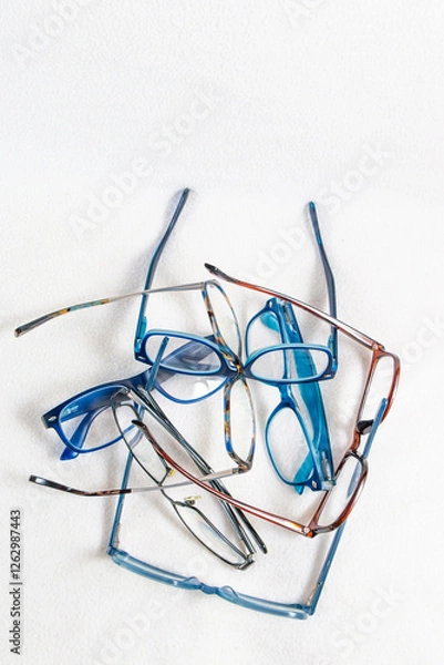 Obraz A stack of reading glasses isolated on a white background