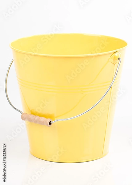 Fototapeta Yellow  iron/metal bucket/pail/container with handle isolated on white background. Colorful kid child toys. Garden equipment.
