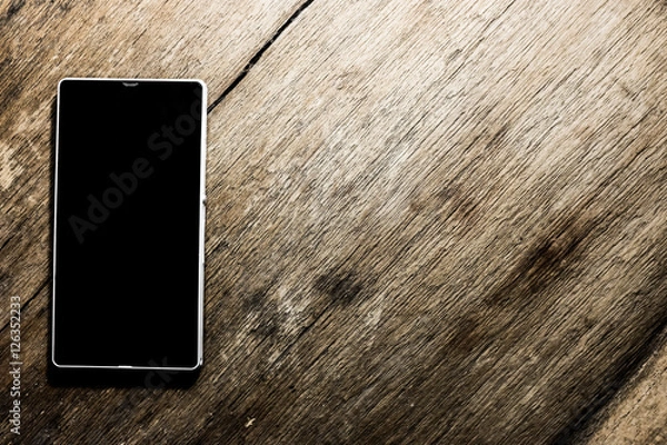 Obraz smartphone on wood background 