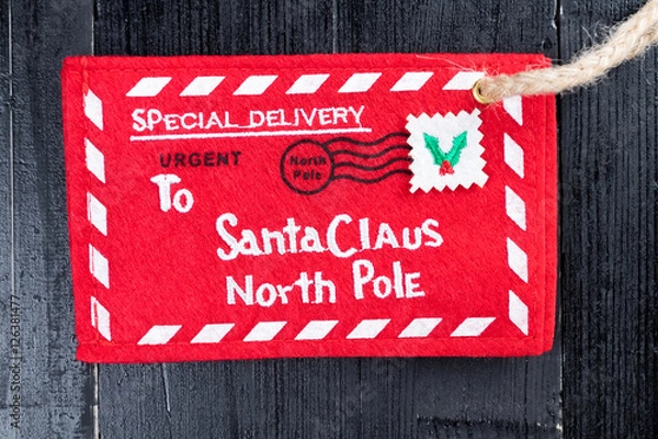 Fototapeta Red letter to Santa Claus envelope with jute twine attached.