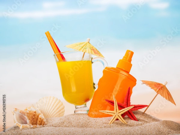 Fototapeta Glass juice, sunscreen, umbrellas, starfish, shells in sand against sea.