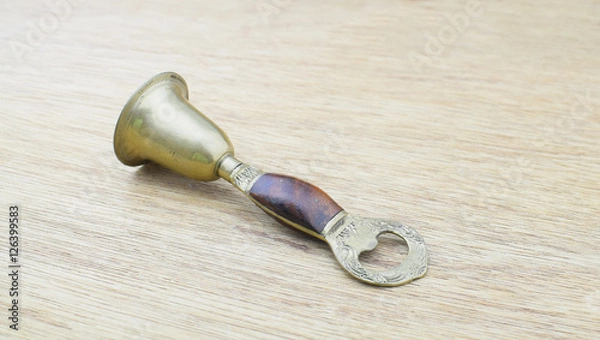 Obraz Ancient bronze bell on wood background