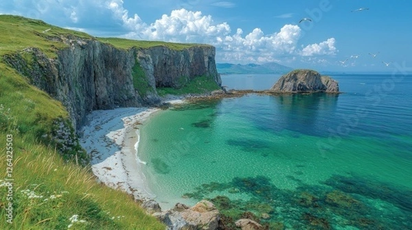 Fototapeta Serene coastal landscape featuring a sandy beach, rocky cliffs, and clear turquoise waters under a blue sky