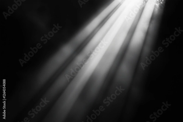 Fototapeta  black and white photo of a light shining on a surface. The light is casting shadows and creating a sense of depth and dimension. The photo has a moody and atmospheric feel