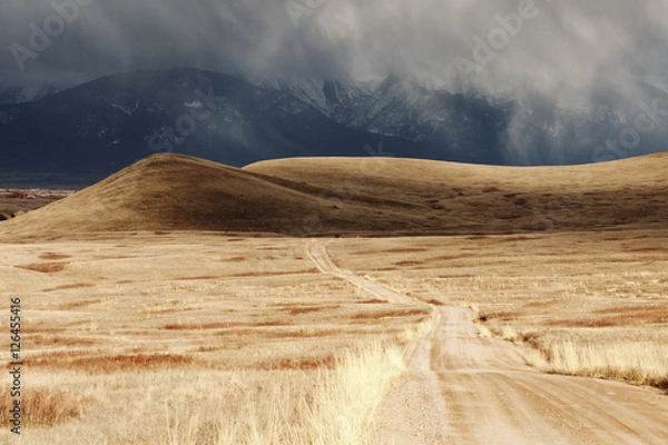 Obraz Storm Cloud Passing Through a Barren Mountain Landscape