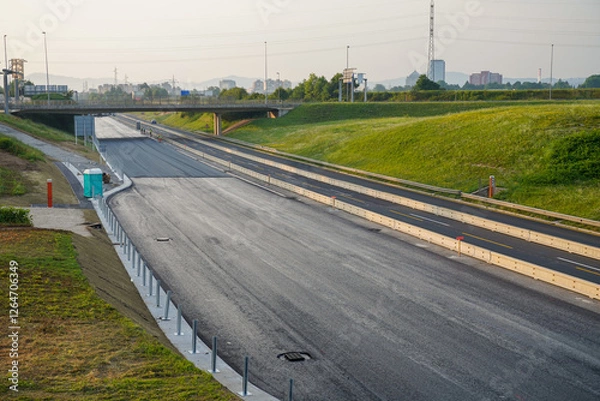 Fototapeta Empty Closed Highway with Fresh Layer of Asphalt and Overpass in the Background