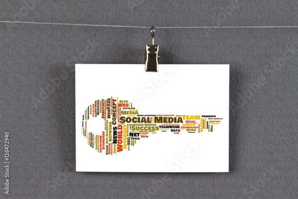 Fototapeta Social Media word cloud shaped as a key on a business card pinned up on a board