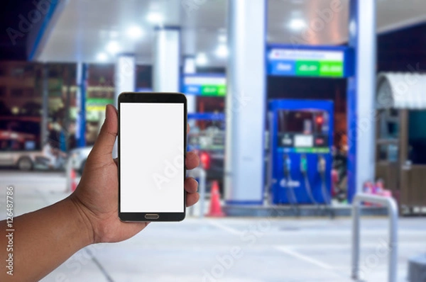 Obraz the hand of man hold mobile phone over blurred car .filling stat