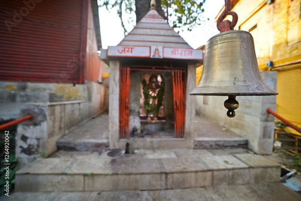 Obraz Brass bell hanging in front of a small temple on the streets of Old Nashik, Maharashtra, India.