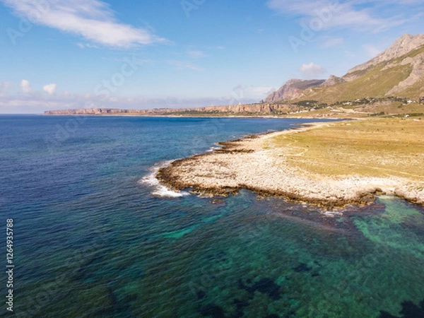 Fototapeta Aerial drone view of Macari (Makari), Sicily. Crystal clear turquoise waters, rugged cliffs, golden sandy beaches. A serene natural landscape with Mediterranean charm near San Vito lo Capo.