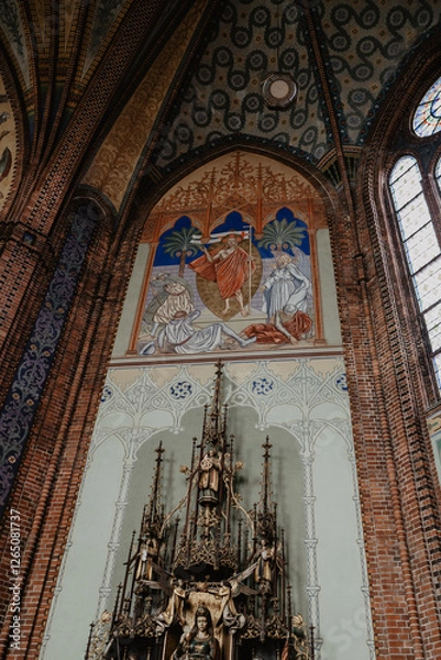 Fototapeta  A stunning interior view of a historic Catholic church featuring an intricately designed altar with Gothic-style wood carvings, a religious fresco 