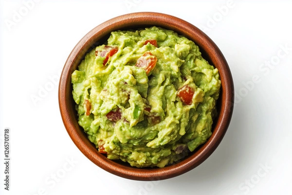 Fototapeta A bowl with guacamole is shown in isolation on white background, viewed from above