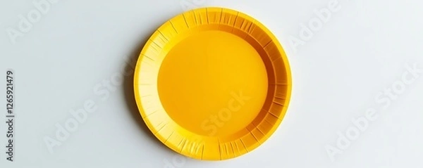 Fototapeta Yellow paper plate displayed on a pristine white surface, top view capture.