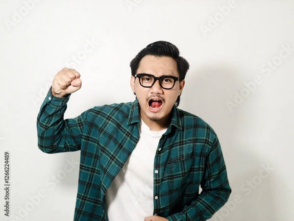 Obraz Asian man looking to the camera and showing angry expression isolated on white background