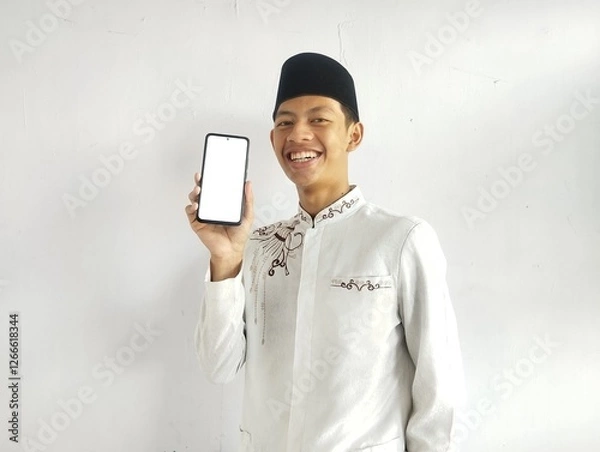 Fototapeta Moslem Asian man smiling and showing blank mobile phone screen