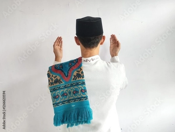 Fototapeta Back view of moslem man doing praying gesture