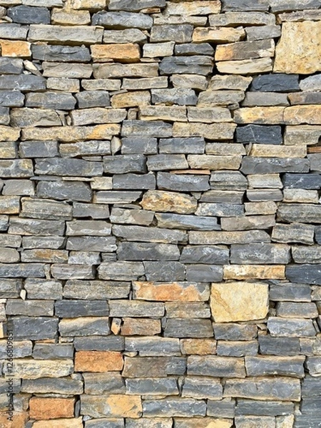 Fototapeta Rustic Stone Wall Texture. Close-up of a stone wall texture, ideal for backgrounds, construction themes, or architectural designs.
