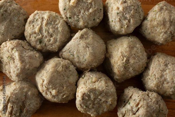 Fototapeta A top down view of a layer of chicken meatballs.
