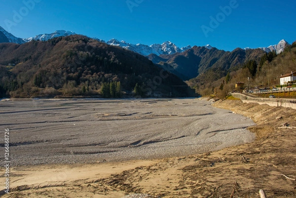 Fototapeta Lago di Barcis - Barcis artificial lake drained of water for routine maintenance, in Friuli-Venezia Giulia, north east Italy. The reservoir was created in 1954 for hydroelectric energy production.