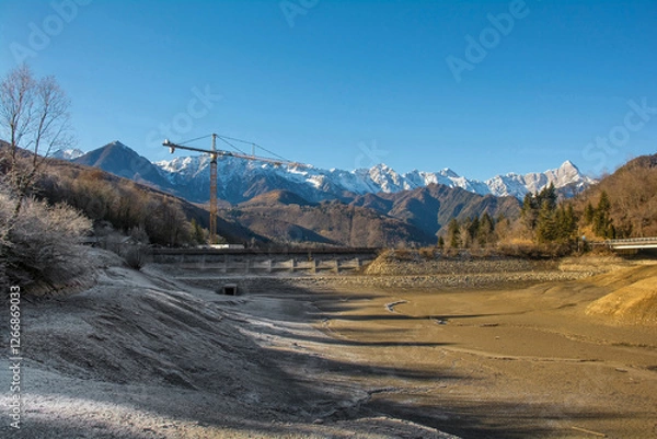 Fototapeta Lago di Barcis - Barcis artificial lake drained of water for routine maintenance, in Friuli-Venezia Giulia, north east Italy. The reservoir was created in 1954 for hydroelectric energy production.