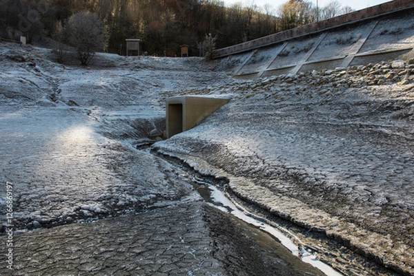 Fototapeta Lago di Barcis - Barcis artificial lake drained of water for routine maintenance, in Friuli-Venezia Giulia, north east Italy. The reservoir was created in 1954 for hydroelectric energy production.