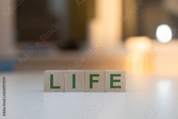 Fototapeta Wooden Cubes on the Table with LIFE Written on Them
