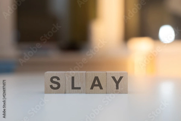 Fototapeta Wooden Cubes on the Table with SLAY Written on Them