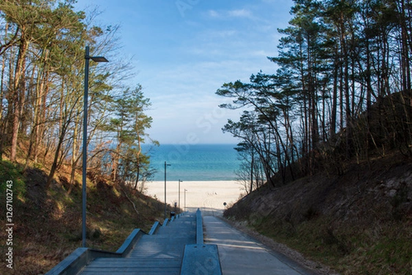 Fototapeta Scenic Stairway Leading to a Sandy Beach with Blue Sea and Sky in Jastrzębia Góra