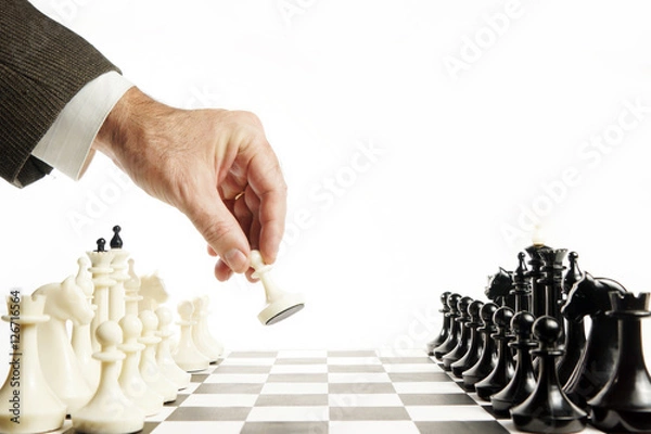 Obraz Man does first move in a chess game. Beginning of competition