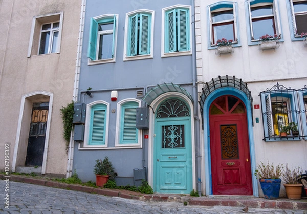 Fototapeta Colorful historic houses with ornate windows in Balat, Istanbul. Touristic district, attractions with historical sites. Colorful streets in Balat. Local and foreign tourists love this place