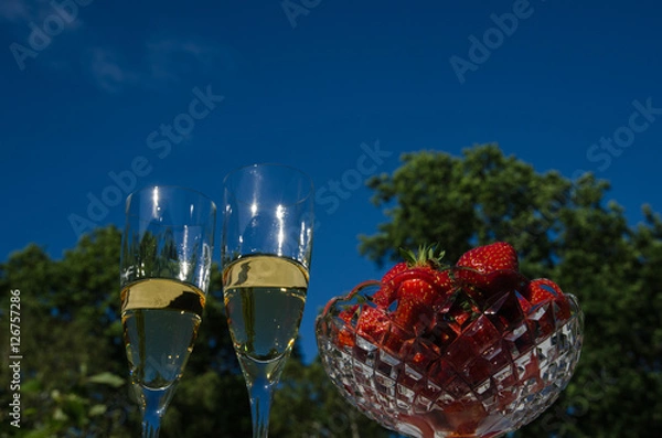 Obraz Two glasses champagne and strawberries in a bowl